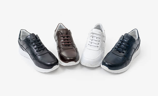 istock 4 different colors of sneakers on a white background 2233996069