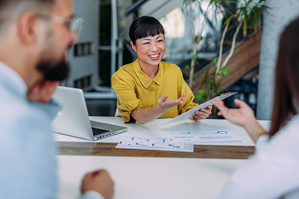 istock Group of business persons talking in the office. 2233997790