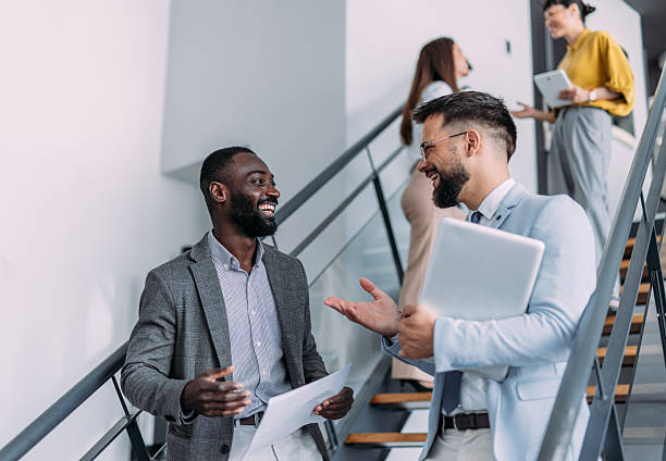 istock Business persons talking on stairs in the office. 2233997854