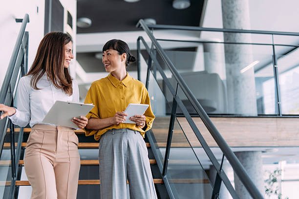 istock Business colleagues talking on stairs in the office. 2233997856