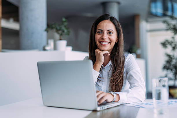 istock Successful businesswoman in modern office working on laptop. 2233997870