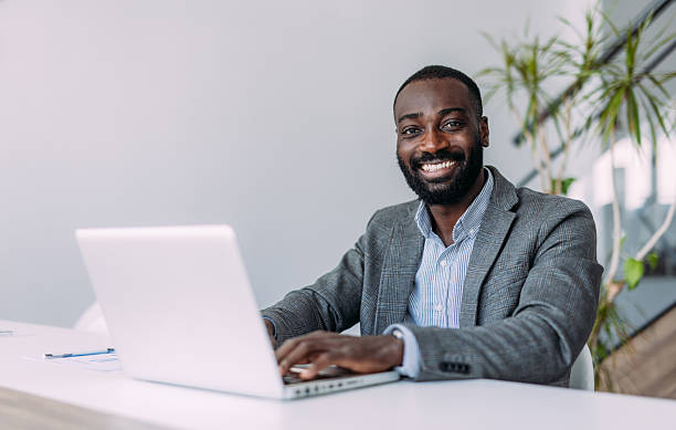 istock Successful businessman in modern office working on laptop. 2233997875