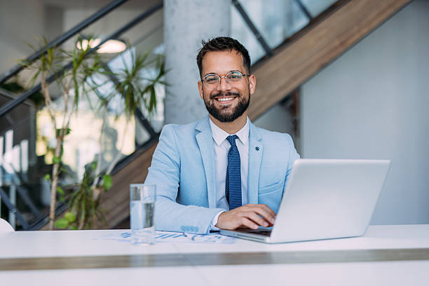 istock Successful businessman in modern office working on laptop. 2233997877