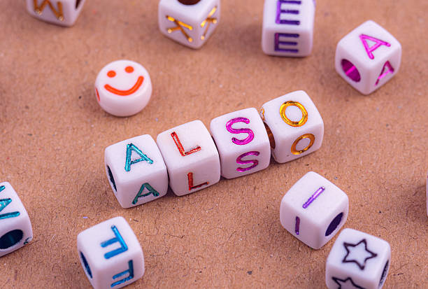 istock Colorful alphabet beads arranged to spell ALSO on a textured surface. 2233998395