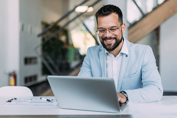 istock Successful businessman in modern office working on laptop. 2233999649