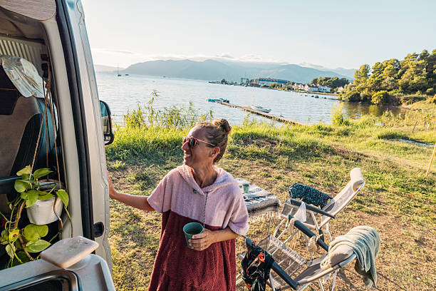 istock Woman Enjoying Lakeside Camping Morning 2234001445
