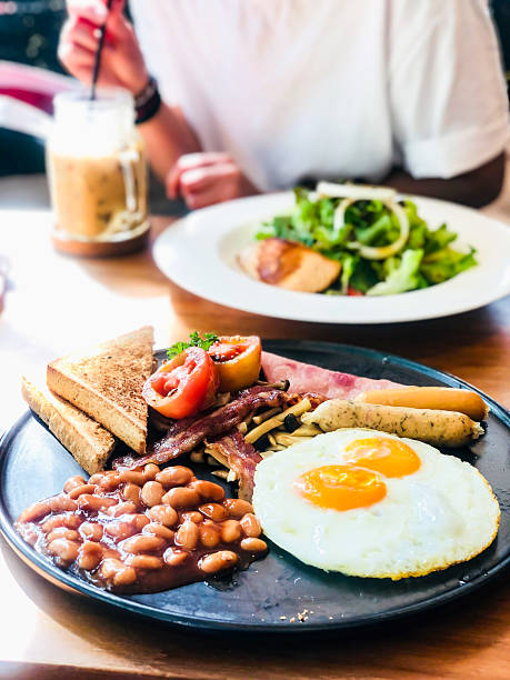 istock English breakfast platter, brunch, fried eggs, tomato beans, bread, vegetables, exquisite breakfast 2234002493