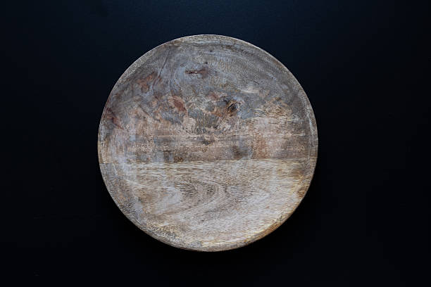 istock Wooden Plate on Black Background 2234006311