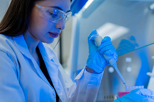 istock Scientist conducts laboratory experiment with pipette under blue lighting in research facility 2234007296