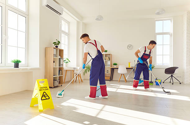 istock Two professional cleaners in uniform diligently clean floor in modern apartment. 2234008917