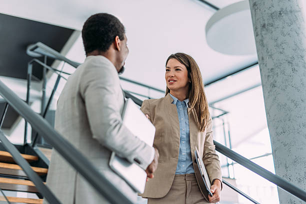 istock Business colleagues talking on stairs in the office. 2234008944