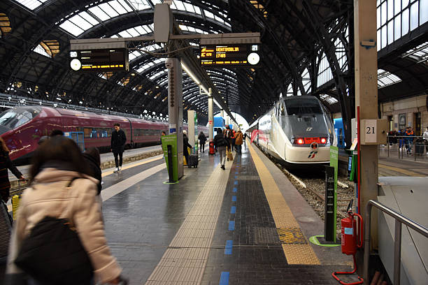 Milan, Italy - March 28, 2022: General view of the monumental entrance portico of Milano Centrale train station in Piazza Duca d'Aosta, inaugurated in 1931.