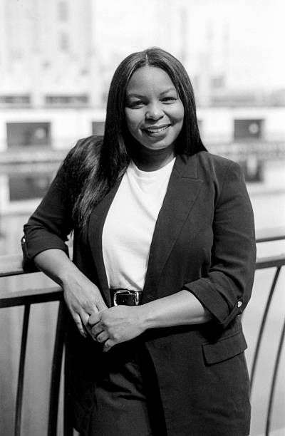 istock Smiling businesswoman leaning on railing in black and white 2234014933