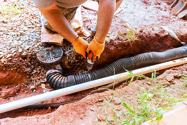 istock Homeowner performing drainage system repair in residential yard during work day 2234014980