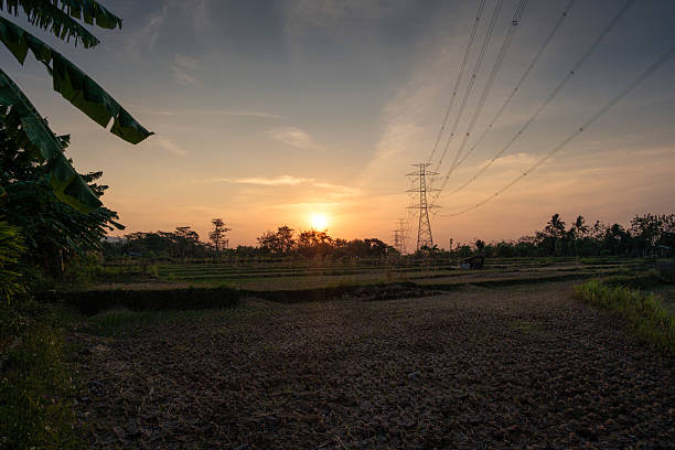 istock Beautiful Sunset Over Rural Fields with Power Lines in Background 2234017954