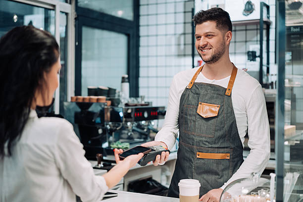 istock Woman making a mobile payment at a cafe. 2234024763