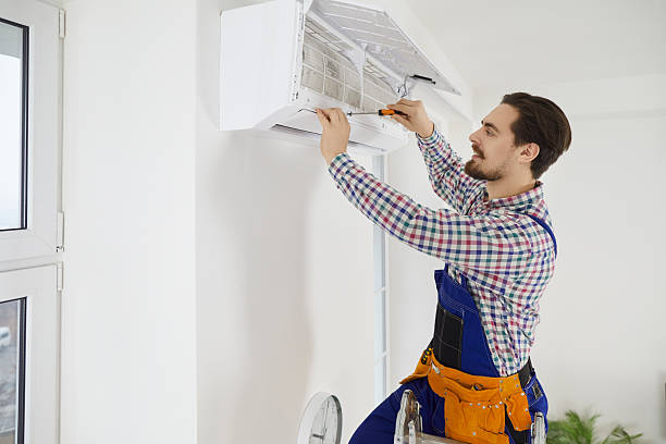 istock Male mechanic fix air conditioner in client home 2234024892