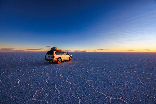 The 4WD on Salar de Uyuni, Altiplano Bolivia Salar de Uyuni (or Salar de Tunupa) is the world's largest salt flat at 10,582 square kilometers (4,086 sq mi). It is located  in the Potosi and Oruro departments in southwest Bolivia, near the crest of the Andes, and is elevated 3,656 meters (11,995  ft) above the mean sea level. The Salar was formed as a result of transformations between several prehistoric lakes.