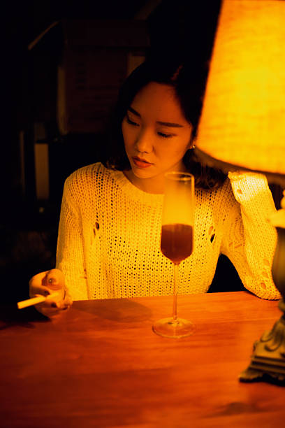 istock The woman drinking red wine at the dining table 2234031566