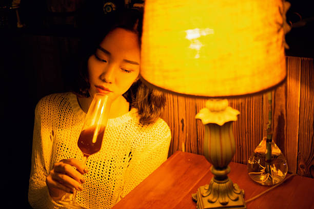 istock The woman drinking red wine at the dining table 2234031577