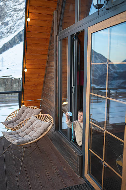 istock Child Holding Camera And Playing In A Cozy Outdoor Setting 2234032589