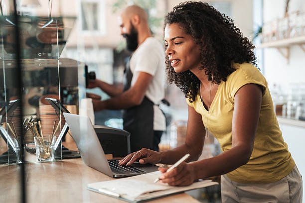 istock Beautiful coffee shop owner managing business documents and tasks 2234043205