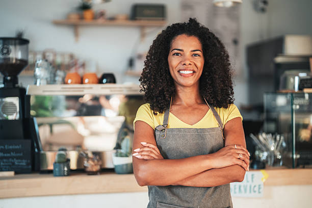 istock Smiling beautiful waitress expecting customers in modern coffee shop 2234043206
