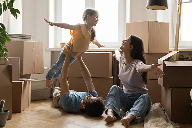 istock Overjoyed couple with small daughter unpack boxes pretend to fly 2234048009