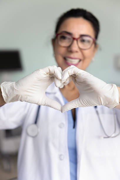 istock Cardiologist forms heart shape with her hands, close up 2234051785