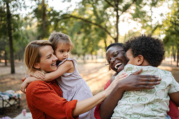 istock Mothers embracing their children in a park 2234054512