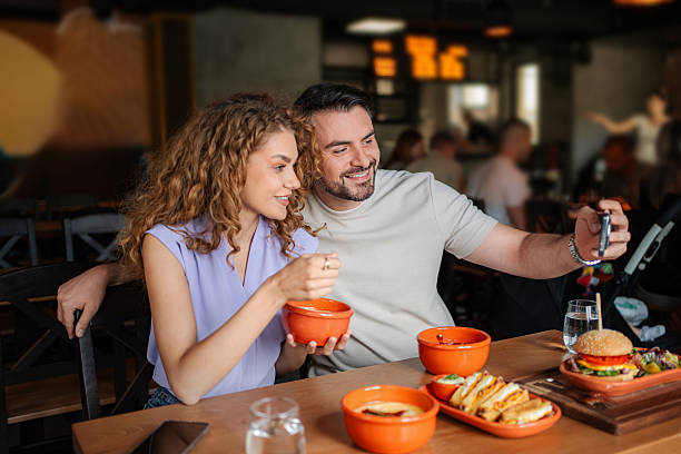 istock Young couple taking selfie while having lunch at restaurant 2234055982