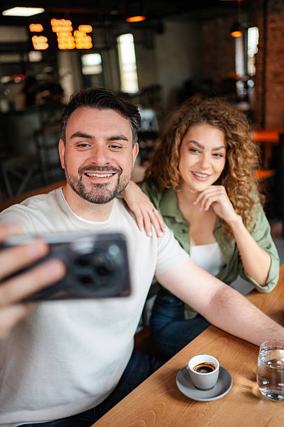istock Couple taking a selfie while having coffee in a cafe 2234056247