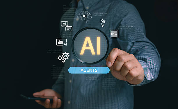 istock Businessman holding a magnifying glass with AI icons and data graphics, representing artificial intelligence agents, machine learning, digital innovation and modern technology solutions. 2234064843