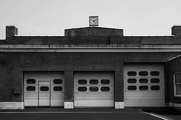 istock Abstract architectural geometry with clock tower and garage doors 2234070232
