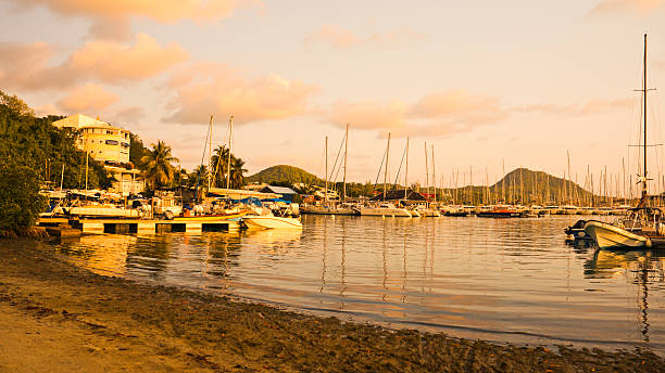 Sandy beach and pale blue sea on the coast of the Caribbean island of Saint Lucia, near the port town of Castries.