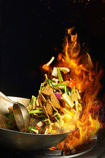 istock Skilled Chinese Chef Executing Traditional 'fire' Stir-Fry Technique,Professional Asian Chef Cooking Savory Dish in Wok 2234074248