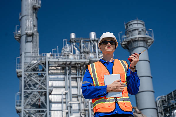 istock Engineer examines industrial architectural plans power plant facility tall structures, pipelines, and towers planning in construction, energy production, and heavy industry operations in a modern industrial environment. 2234076250