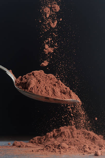 istock Dark cocoa falling onto a spoon. Scene shown against a dark background 2234087088