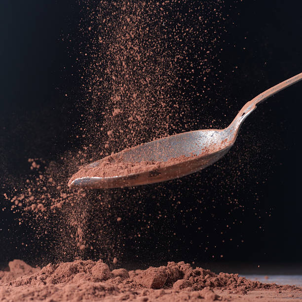 istock Dark cocoa falling onto a spoon. Scene shown against a dark background 2234087093