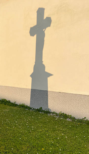 istock Shadow of a crucifix projected on a wall in a cemetery 2234087368