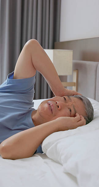 istock man struggling with insomnia in bed 2234089118