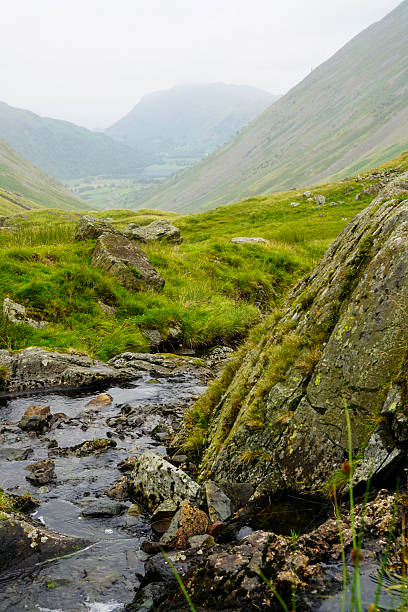 istock Cumbrian landscape with stream and distant lake 2234091394