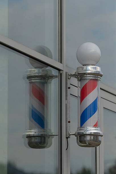 istock Classic Barber Shop Pole Reflecting in Glass Window 2234093181