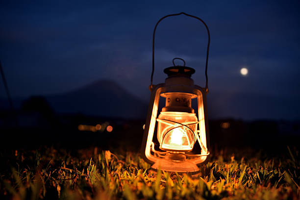 vintage lantern on the log in the evening