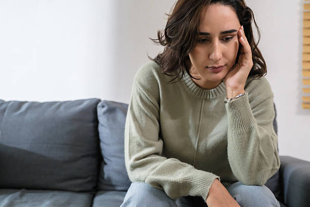 istock Sad anxious woman feeling stress and depression while sitting alone on sofa, suffering emotional problem and mental frustration at home 2234097482