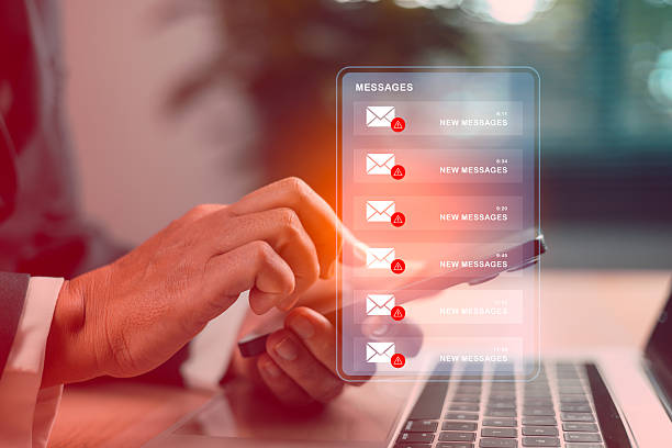 istock Businessman using smartphone with spam email phishing alerts on virtual screen, concept of cybersecurity threat, online fraud, scam messages, data protection, malware attack and IT security. warning 2234098508