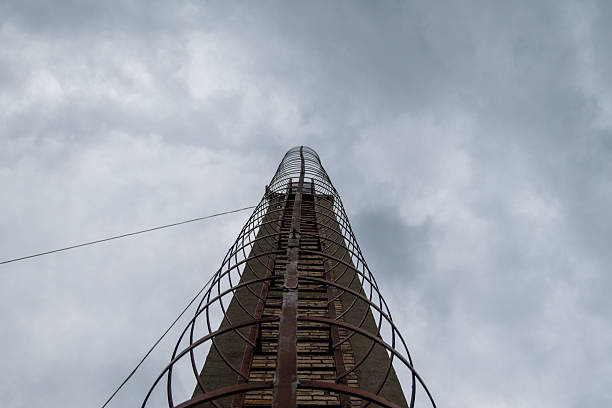 Industrial ladder on tall chimney