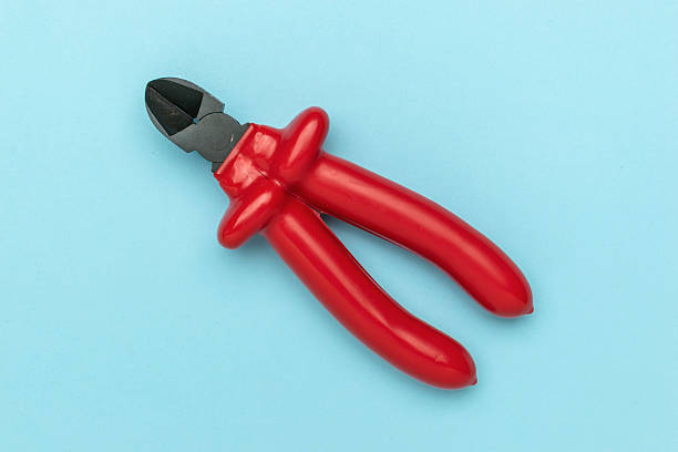 Red Handled Wire Cutter on Blue Background Highlighting DIY and Tool Themes