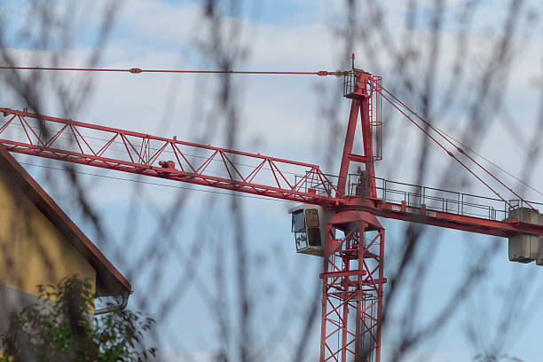 istock A Red Construction Crane Stands Tall Against the Clear Blue Sky 2234099713