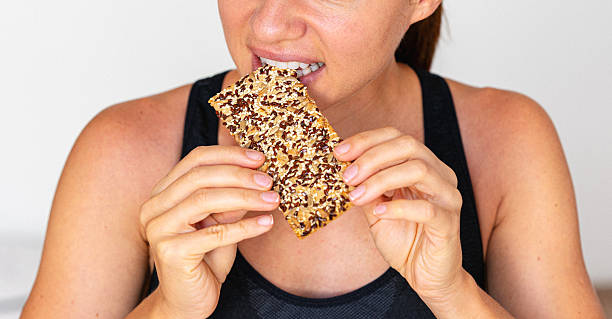 istock Close-up photo woman eating seeded cracker. 2234103181